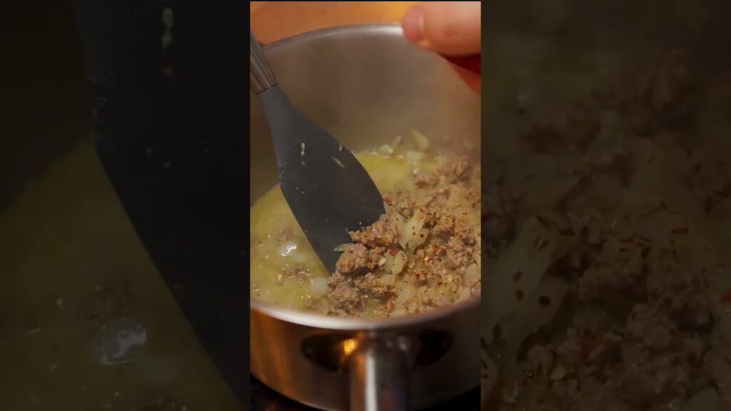 Agrega la carne, el arroz y las especias al guiso.