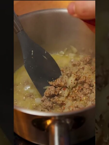 Agrega la carne, el arroz y las especias al guiso.